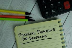 Financial Planning For Veterans write on sticky notes isolated on office desk. photo