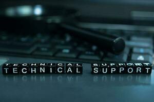 Technical Support text wooden blocks in laptop background. Business and technology concept photo