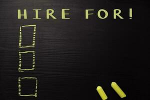 Hire For written with color chalk. Supported by an additional services. Blackboard concept photo
