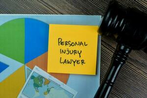 Concept of Personal Injury Lawyer write on sticky notes isolated on Wooden Table. photo