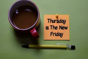 Thursday is the New Friday write on a sticky note isolated on office desk. photo