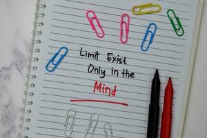 Limit Exist Only In The Mind write on a book isolated wooden table. photo