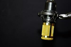 Close-up of retro microphone isolated on bokeh black background photo