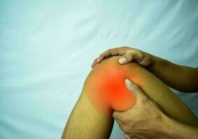suffering from joint pain with red spot. Hands on leg as hurt from Arthritis. Osteoarthritis knee disease concept photo