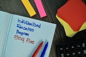 Individualized Education Program 504 Plan write on sticky note isolated on Wooden Table. Financial Concept photo