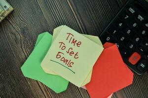 Time to Set Goals write on sticky note isolated on Wooden Table. Motivation Inspiration concept photo