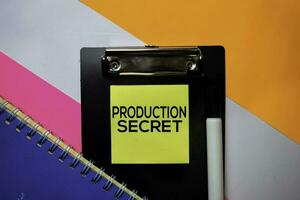 Production Secret text on sticky notes with color office desk concept photo