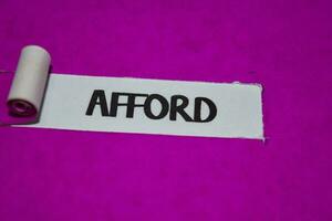 Afford text, Inspiration and positive vibes concept on purple torn paper photo