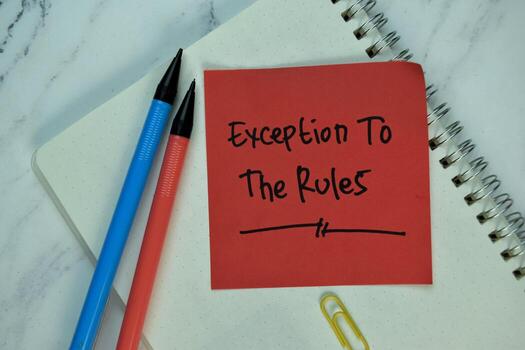 Exception to the Rules write on sticky note isolated on Wooden Table. photo