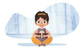 un contento niña se sienta en un loto posición y sostiene un regalo caja en su manos. vector ilustración.