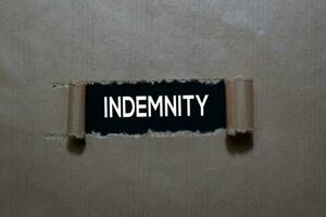 Close up Indemnity write inside on torn paper photo