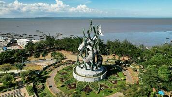 Aerial view of the A giant shark and crocodile statue as a symbol of the city of Surabaya. A landmark or monument as an icon of Surabaya city. East Java, Indonesia, August 28, 2022 photo