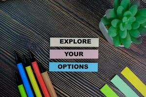 Explore Your Options write on sticky notes isolated on Wooden Table. photo