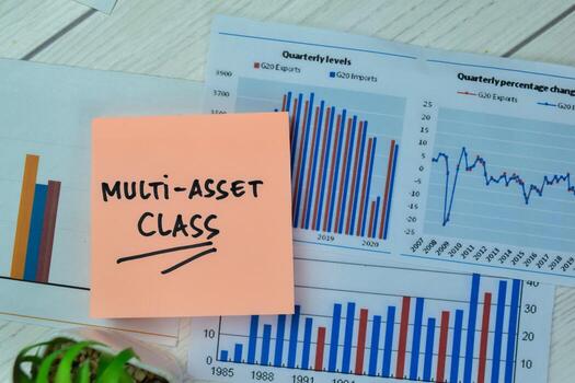 Concept of Multi-Asset Class write on sticky notes with statistics isolated on Wooden Table. photo