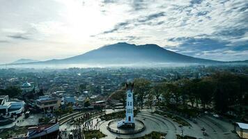 Aerial view of Jam Gadang, a historical and most famous landmark in BukitTinggi City, an icon of the city and the most visited tourist destination by tourists. Bukittinggi, Indonesia, January 25, 2023 photo