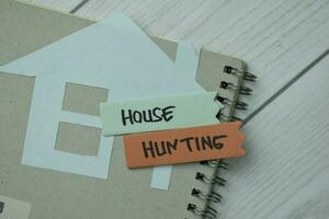 House Hunting write on sticky notes isolated on office desk. photo