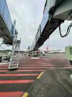 Indonesian Airlines Plane in front of terminal at Praya Lombok Airport. Lombok, Indonesia, March 22, 2022 photo