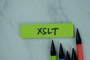 XSLT write on sticky notes isolated on Wooden Table. photo