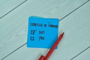 Concept of No Conflict of Interest write on sticky notes isolated on Wooden Table. photo