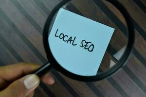 Local SEO write on sticky notes isolated on Wooden Table. photo