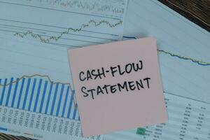 Concept of Cash-Flow Statement write on sticky notes isolated on Wooden Table. photo