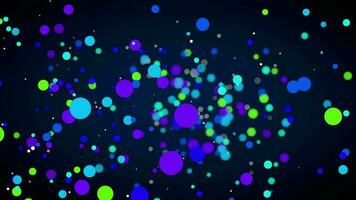 Group of blue, light blue, green and purple round particles floating against defocused black background. Loop sequence. 3D Animation video