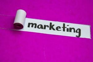 Marketing text, Inspiration, Motivation and business concept on purple torn paper photo