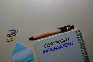 Copyright Infringement write on a book isolated on Office Desk photo