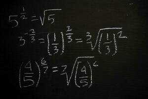 Close up math formulas written on a blackboard. Education concept photo