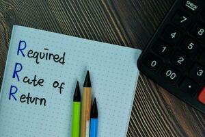 Required Rate of Return write on a book isolated on office desk. photo
