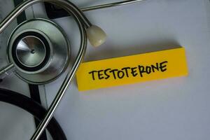 Testoterone write on sticky notes isolated on Wooden Table. photo