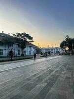 View of Fatahilah museum at Old City at Jakarta, Indonesia. With Jakarta cityscape and noise cloud when sunset. Jakarta, Indonesia, August 30, 2022 photo