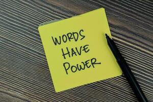 Words Have Power write on sticky notes isolated on Wooden Table. photo