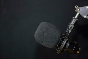 Close-up of retro microphone isolated on bokeh black background photo