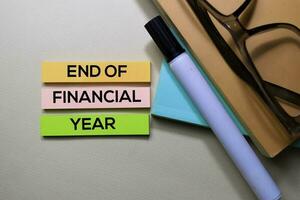 End of Financial Year text on sticky notes isolated on office desk photo