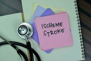 Concept of Ischeme Stroke write on sticky notes with gavel isolated on Wooden Table. photo