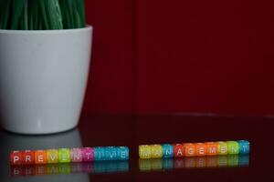 Preventive management text at colorful wooden block on red background. Desk office and education concept photo