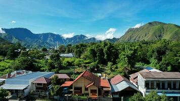 Aerial view of some agricultural fields in Sembalun. Sembalun is situated on the slope of mount Rinjani and is surrounded by beautiful green mountains. Lombok, Indonesia, March 22, 2022 photo