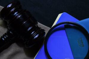 Passport and Black Judges gavel on office desk. Immigration law concept photo