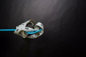 Tape with blue fork isolated on black background. Healthy eating concept photo