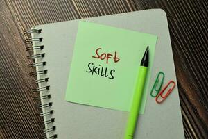 Soft Skills write on sticky note isolated on Wooden Table. Business Concept photo