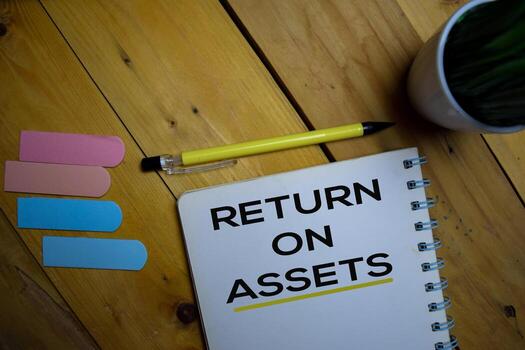 Return on Assets write on a book isolated on wooden background. photo