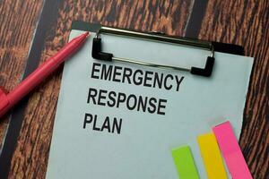 Emergency Response Plan write on a paperwork isolated on office desk. photo