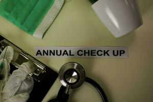 Annual Check up with inspiration and healthcare medical concept on desk background photo