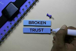 Broken Trust text on sticky notes isolated on office desk photo