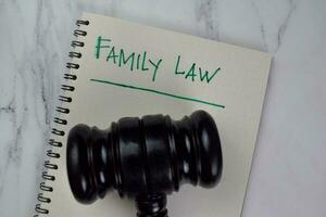 Family Law write on a book isolated on Wooden Table. photo