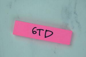 GTD - Getting Things Done write on sticky notes isolated on Wooden Table. photo