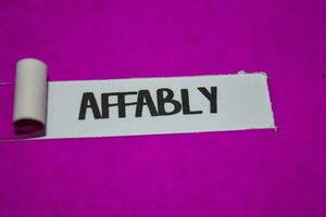 Affably text, Inspiration and positive vibes concept on purple torn paper photo