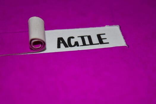 Agile text, Inspiration and positive vibes concept on purple torn paper photo