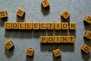 Collection Point on wooden cubes. On table background photo